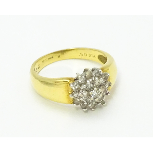 729 - An 18ct gold ring  set with diamond cluster. Ring size approx. L.