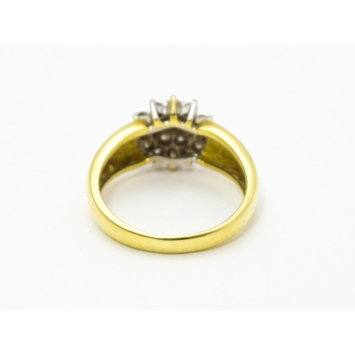 729 - An 18ct gold ring  set with diamond cluster. Ring size approx. L.