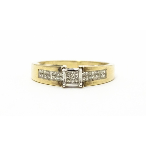 730 - A 9ct gold ring set with 9 central diamonds flanked by a further 14 diamonds to each shoulder. Ring ... 