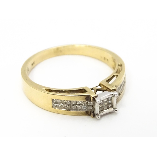 730 - A 9ct gold ring set with 9 central diamonds flanked by a further 14 diamonds to each shoulder. Ring ... 