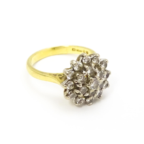 732 - An 18ct gold ring set with diamond cluster. Ring size approx. J