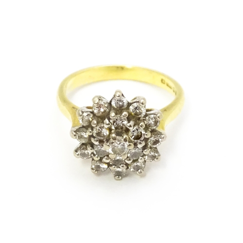 732 - An 18ct gold ring set with diamond cluster. Ring size approx. J