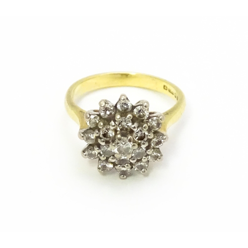 732 - An 18ct gold ring set with diamond cluster. Ring size approx. J