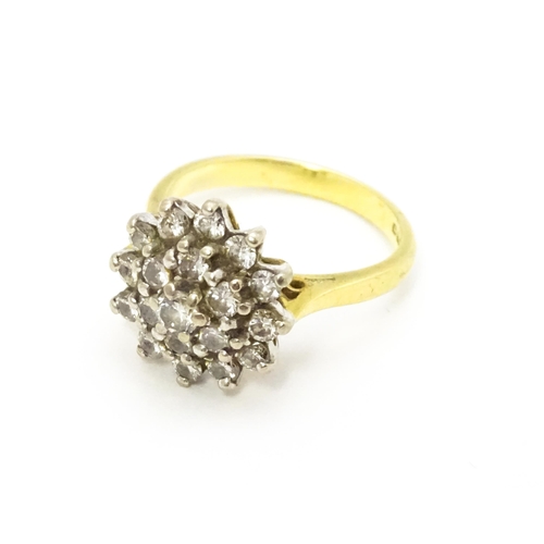 732 - An 18ct gold ring set with diamond cluster. Ring size approx. J