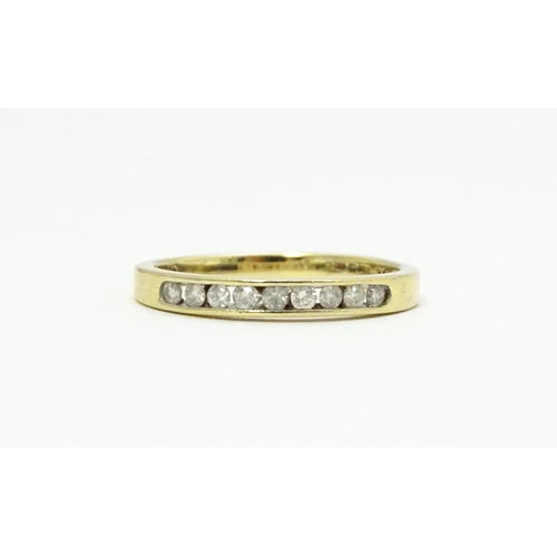 733 - A 9ct gold ring set with 9 diamonds in a linear setting. Ring size approx. P