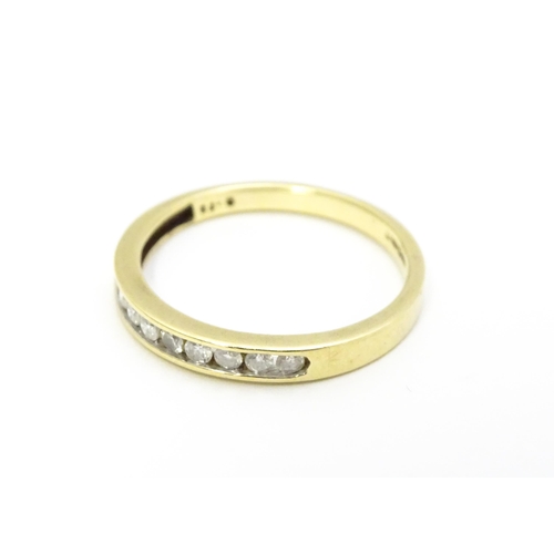 733 - A 9ct gold ring set with 9 diamonds in a linear setting. Ring size approx. P