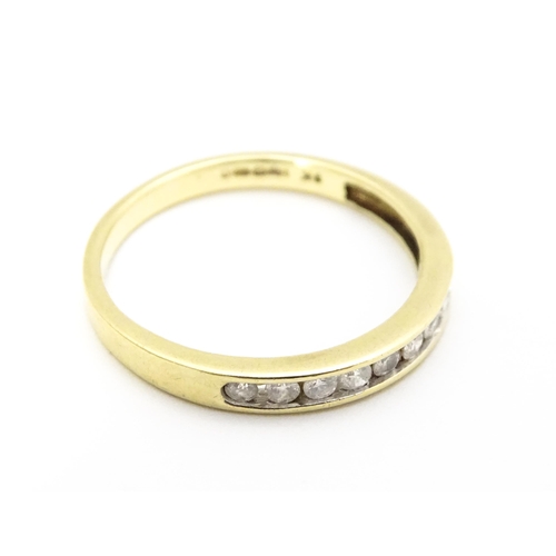 733 - A 9ct gold ring set with 9 diamonds in a linear setting. Ring size approx. P