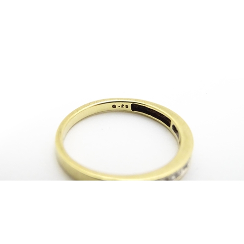 733 - A 9ct gold ring set with 9 diamonds in a linear setting. Ring size approx. P