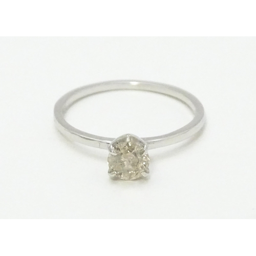 735 - A 14ct white gold ring set with diamond solitaire. Ring size approx. M 1/2