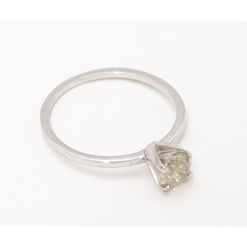 735 - A 14ct white gold ring set with diamond solitaire. Ring size approx. M 1/2