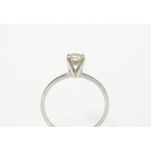 735 - A 14ct white gold ring set with diamond solitaire. Ring size approx. M 1/2