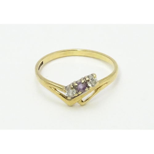 736 - A 9ct gold ring set with three stones. Ring size approx. M 1/2