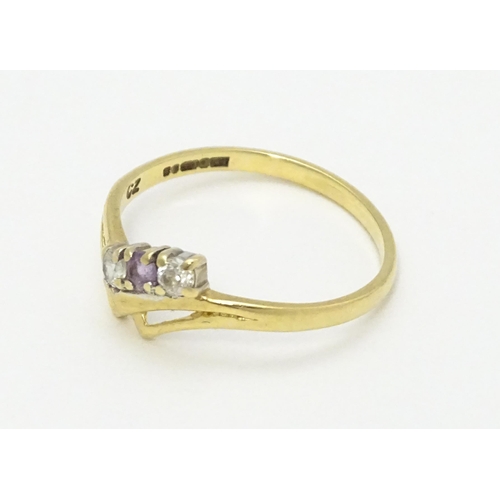 736 - A 9ct gold ring set with three stones. Ring size approx. M 1/2