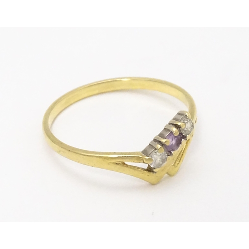 736 - A 9ct gold ring set with three stones. Ring size approx. M 1/2