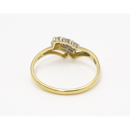 736 - A 9ct gold ring set with three stones. Ring size approx. M 1/2