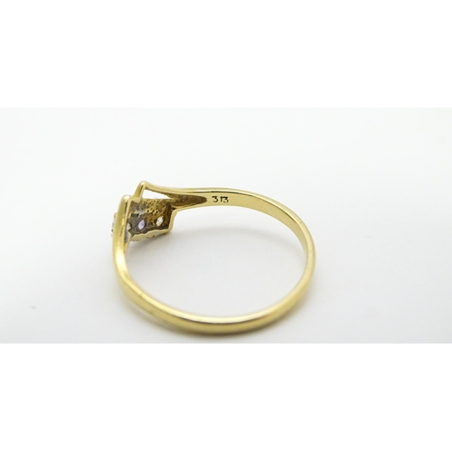 736 - A 9ct gold ring set with three stones. Ring size approx. M 1/2