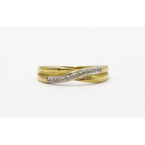 737 - A 9ct gold ring set with diamonds in a crossover setting. Ring size approx. J