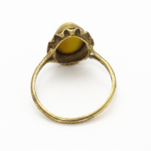 738 - A 9ct gold ring set with tigers eye cabochon. Ring size approx.  N 1/2