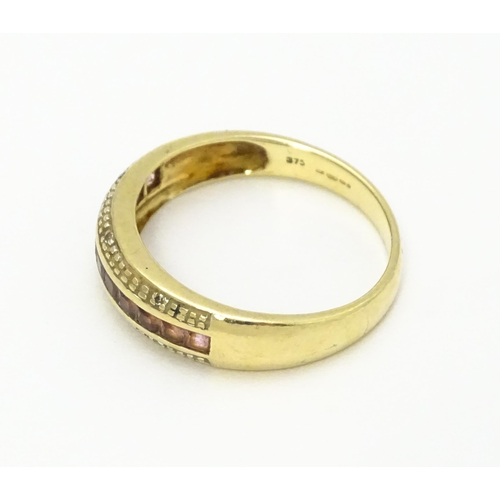 739 - A 9ct gold ring set with pink stones in a linear setting and chip set diamonds. Ring size approx. Q