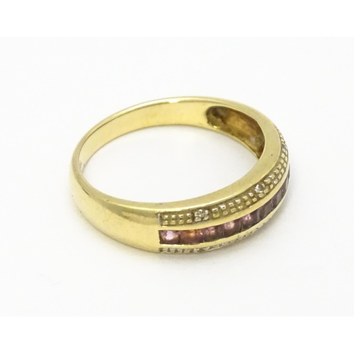 739 - A 9ct gold ring set with pink stones in a linear setting and chip set diamonds. Ring size approx. Q