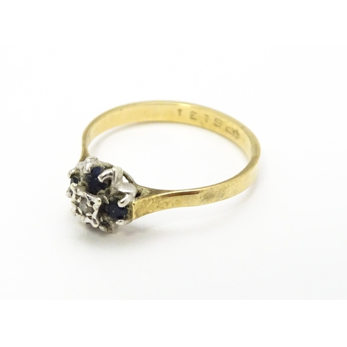 741 - A 9ct gold ring set with diamonds and blue stones. Ring size approx. L