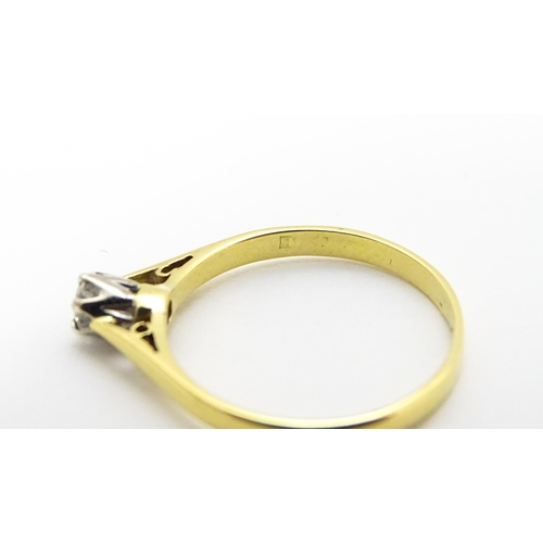 742 - An 18ct gold diamond solitaire ring. Ring size approx.  M