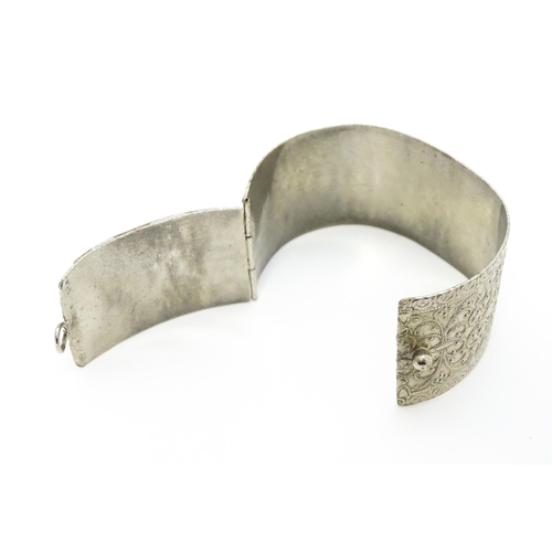 743 - A white metal bracelet of cuff form set with blue cabochon detail.