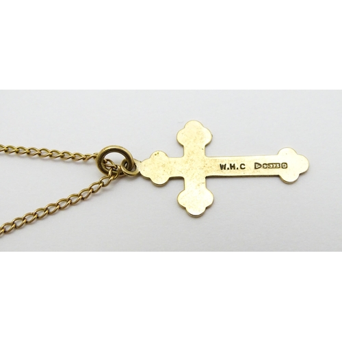 744 - A 9ct gold pendant of cross form, on a yellow metal chain. Pendant approx. 1