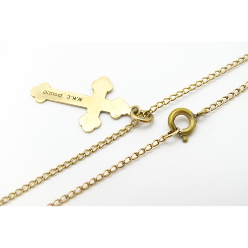 744 - A 9ct gold pendant of cross form, on a yellow metal chain. Pendant approx. 1