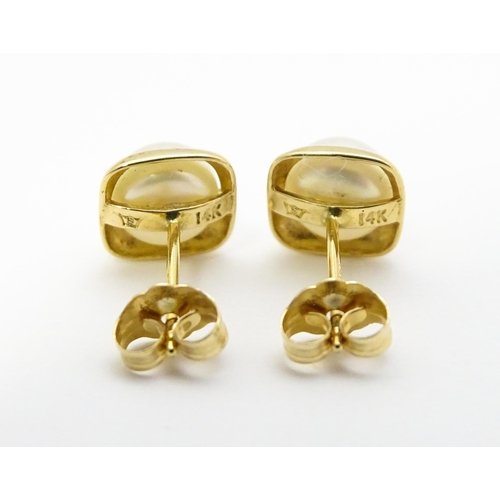 749 - A 14ct gold ring set with central pearl. Ring size approx. M. Together with a pair of stud earrings ... 