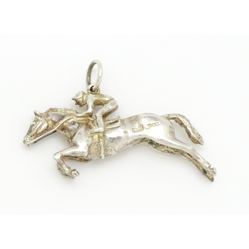 756 - A silver pendant modelled as a racehorse and jockey hallmarked London 1983, maker HG. Approx. 1 1/2