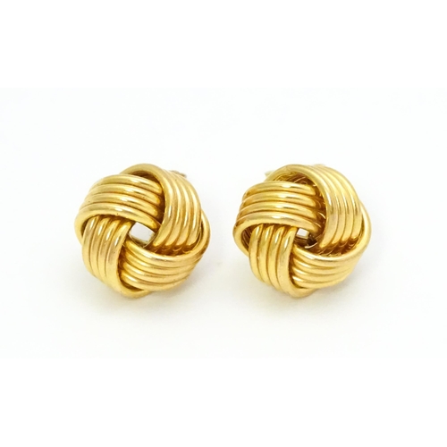 757 - A pair of 9ct gold stud earrings with knot detail. Approx. 1/2