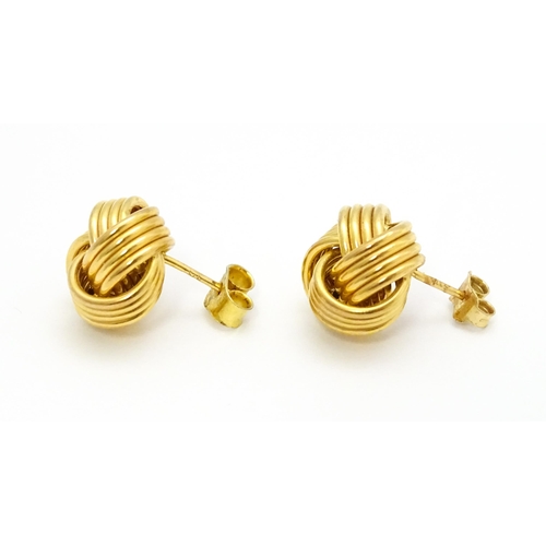 757 - A pair of 9ct gold stud earrings with knot detail. Approx. 1/2