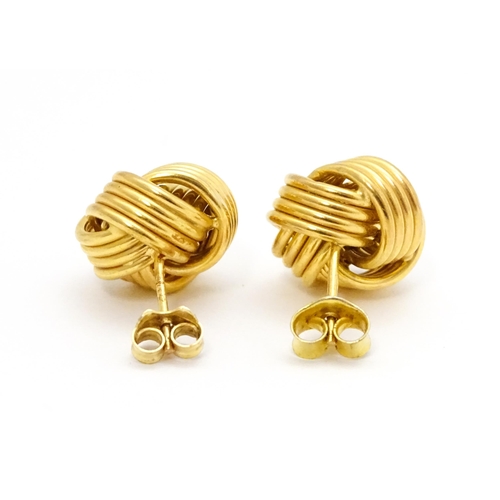 757 - A pair of 9ct gold stud earrings with knot detail. Approx. 1/2