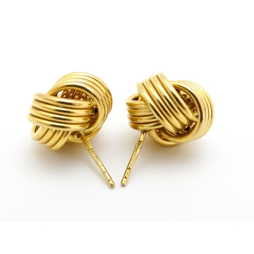 757 - A pair of 9ct gold stud earrings with knot detail. Approx. 1/2