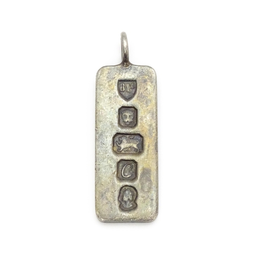 759 - A silver pendant of ingot form hallmarked London 1977 with Silver Jubilee mark, together with a hall... 