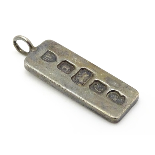 759 - A silver pendant of ingot form hallmarked London 1977 with Silver Jubilee mark, together with a hall... 