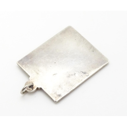 759 - A silver pendant of ingot form hallmarked London 1977 with Silver Jubilee mark, together with a hall... 