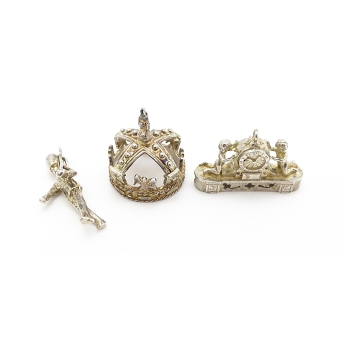 764 - Three novelty pendant charms formed as a crown, solider and clock. The soldier approx 1 1/4