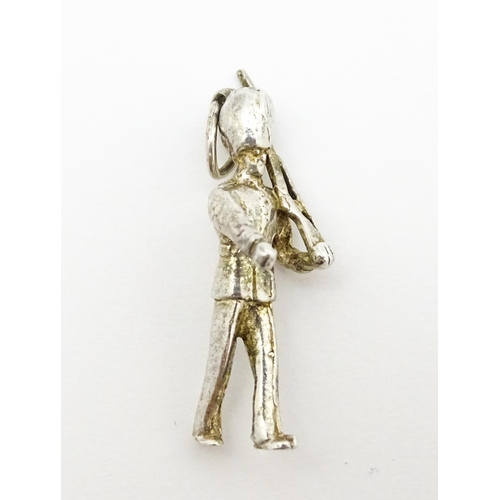 764 - Three novelty pendant charms formed as a crown, solider and clock. The soldier approx 1 1/4