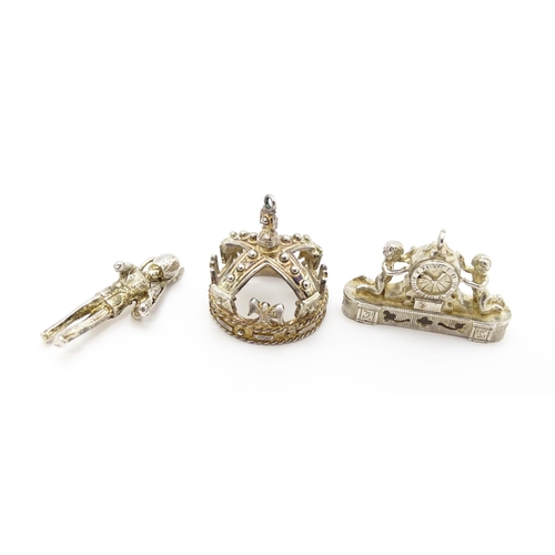 764 - Three novelty pendant charms formed as a crown, solider and clock. The soldier approx 1 1/4