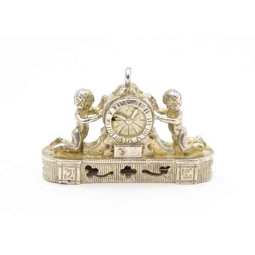 764 - Three novelty pendant charms formed as a crown, solider and clock. The soldier approx 1 1/4