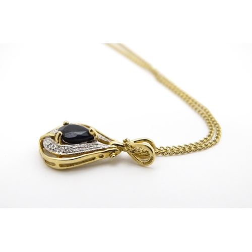 766 - A 9ct gold pendant set with central dark blue stone and chip set diamonds together with a gilt and w... 