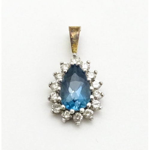 766 - A 9ct gold pendant set with central dark blue stone and chip set diamonds together with a gilt and w... 