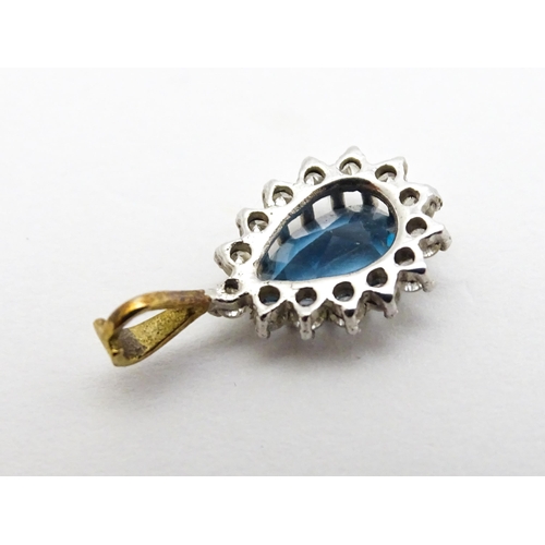 766 - A 9ct gold pendant set with central dark blue stone and chip set diamonds together with a gilt and w... 