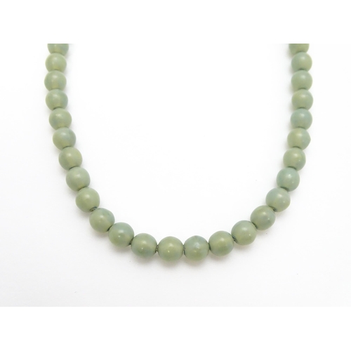 768 - A graduated pearl necklace with 9ct gold clasp. Together with a jade green coloured glass bead neckl... 