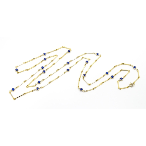 769 - A gilt metal chain necklace set with blue beads. Together with a gilt metal ring set with three whit... 