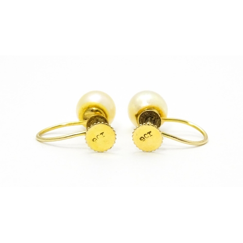 770 - A pair of 9ct gold screw back earrings set with pearls