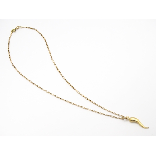 771 - A yellow metal pendant formed as an Italian twisted horn, on a 9ct gold chain. Pendant approx. 1