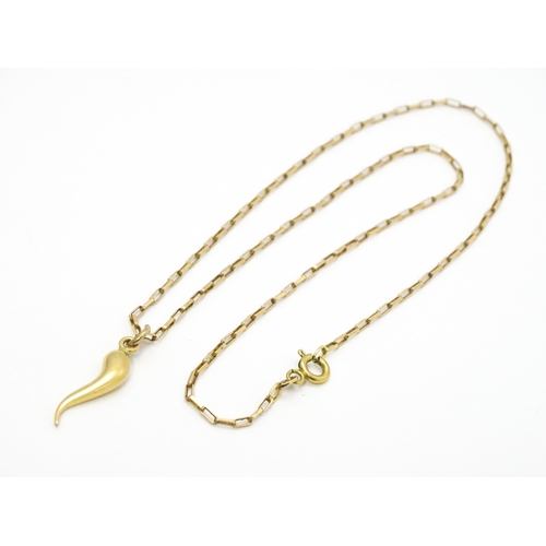 771 - A yellow metal pendant formed as an Italian twisted horn, on a 9ct gold chain. Pendant approx. 1